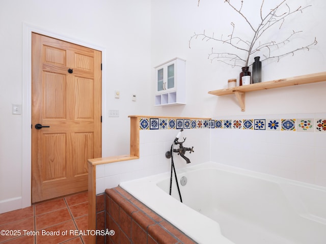 full bath featuring a garden tub and tile patterned flooring