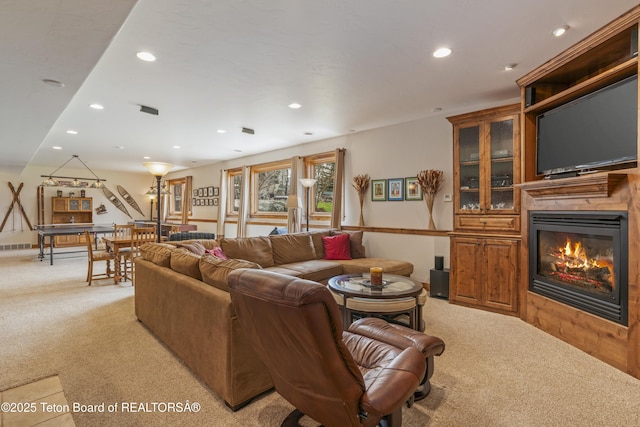2035 Tomahawk Trl, Victor, ID 83455 - living area with a glass covered fireplace, light carpet, and recessed lighting