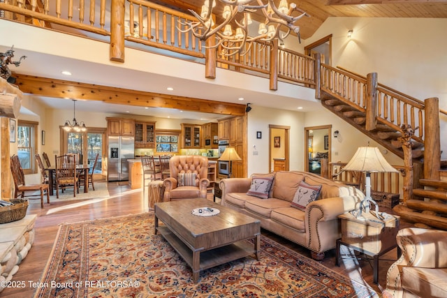 25640 Buffalo Run, Moran, WY 83013 - living area with a chandelier, light wood-style floors, high vaulted ceiling, stairway, and recessed lighting