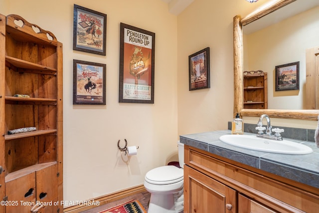 25640 Buffalo Run, Moran, WY 83013 - half bathroom featuring vanity and toilet