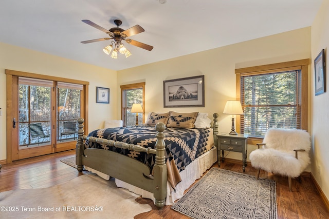 25640 Buffalo Run, Moran, WY 83013 - bedroom with access to exterior, hardwood / wood-style floors, baseboards, and a ceiling fan