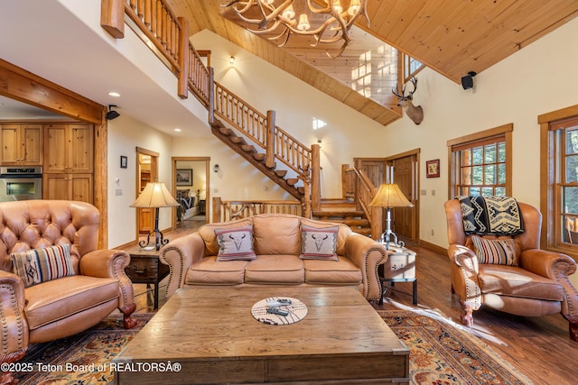 25640 Buffalo Run, Moran, WY 83013 - living room featuring a chandelier, high vaulted ceiling, hardwood / wood-style flooring, stairs, and wooden ceiling