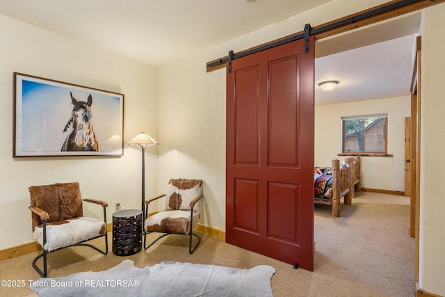 25640 Buffalo Run, Moran, WY 83013 - living area featuring carpet floors, a barn door, and baseboards