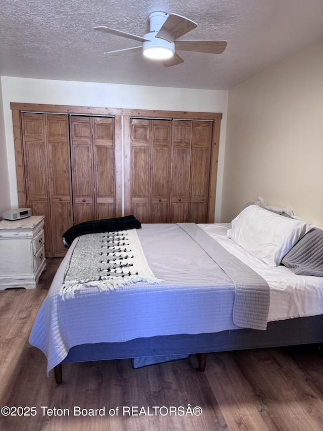 bedroom with a textured ceiling, a ceiling fan, and wood finished floors