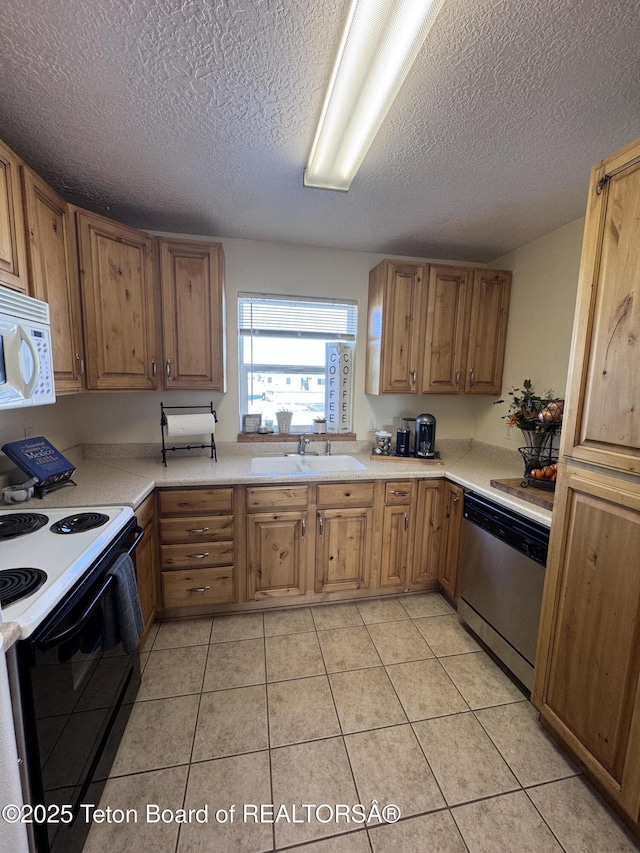 kitchen with a sink, black / electric stove, light countertops, white microwave, and dishwasher