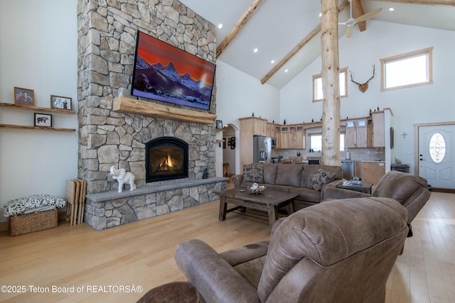 4535 Roxanne St, Tetonia, ID 83452 - living area featuring high vaulted ceiling, light wood-style floors, beamed ceiling, and a fireplace