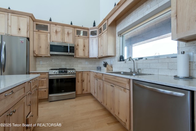 4535 Roxanne St, Tetonia, ID 83452 - kitchen with appliances with stainless steel finishes, light brown cabinetry, a sink, and decorative backsplash