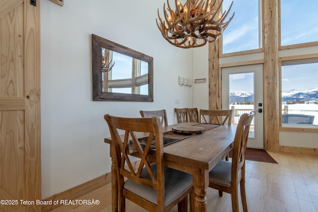 4535 Roxanne St, Tetonia, ID 83452 - dining room featuring a chandelier, light wood-type flooring, and a towering ceiling
