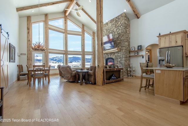 4535 Roxanne St, Tetonia, ID 83452 - living area featuring high vaulted ceiling, beamed ceiling, plenty of natural light, a fireplace, and arched walkways