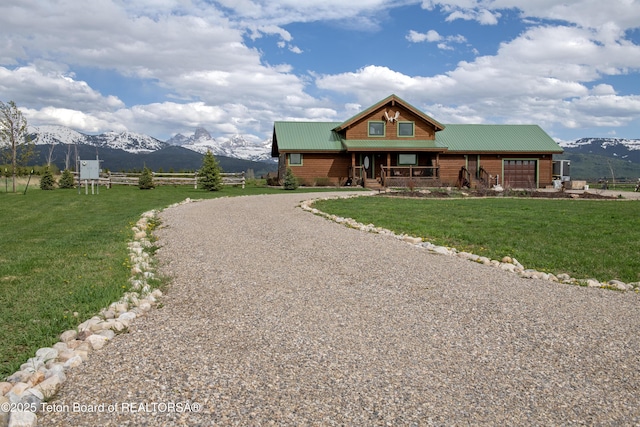 4535 Roxanne St, Tetonia, ID 83452 - cabin with a garage, gravel driveway, a mountain view, and covered porch