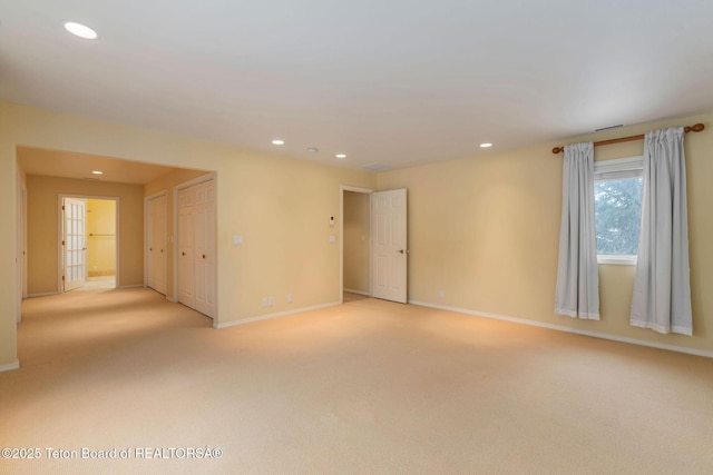 unfurnished room with recessed lighting, light colored carpet, and baseboards