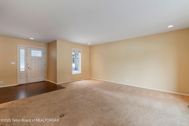 foyer entrance with recessed lighting, carpet, and baseboards