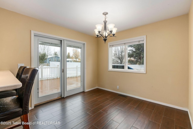 unfurnished office featuring an inviting chandelier, visible vents, baseboards, and wood finish floors