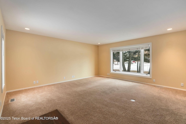 unfurnished room with recessed lighting, visible vents, carpet flooring, and baseboards