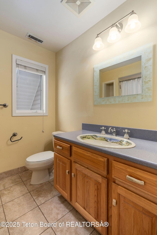 full bath featuring visible vents, toilet, vanity, and tile patterned flooring