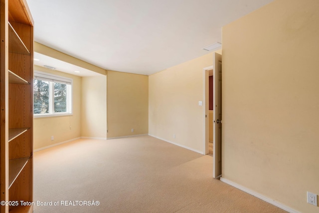 unfurnished room with baseboards, carpet floors, and visible vents