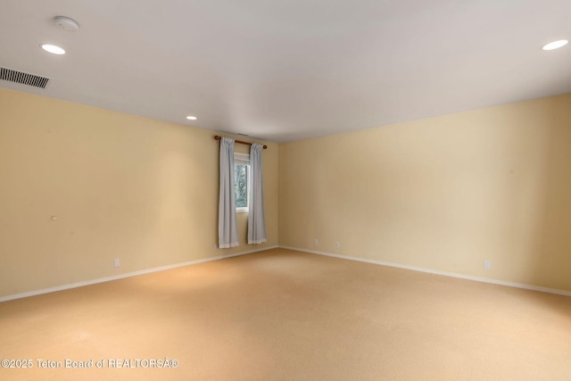 empty room with recessed lighting, visible vents, baseboards, and carpet