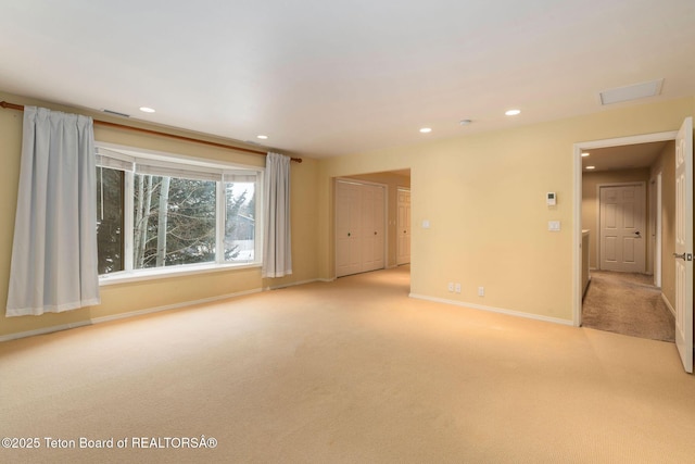 carpeted empty room with recessed lighting, visible vents, and baseboards