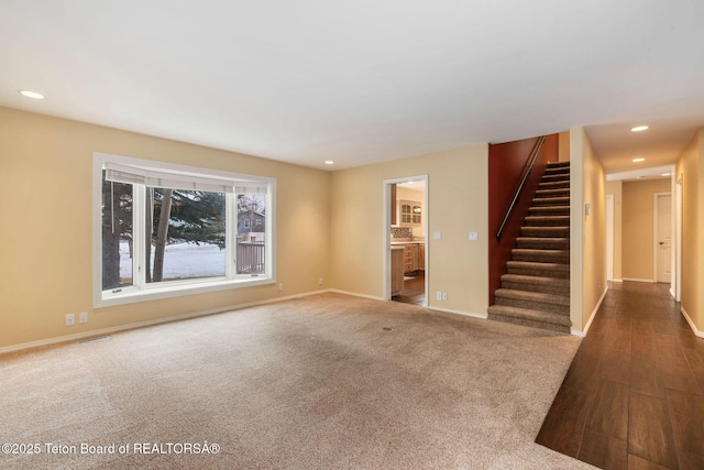 unfurnished living room with visible vents, recessed lighting, carpet floors, baseboards, and stairs