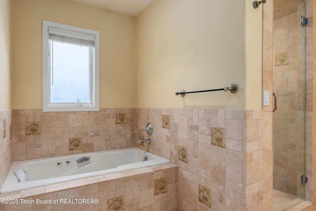 full bathroom with a shower stall and a garden tub