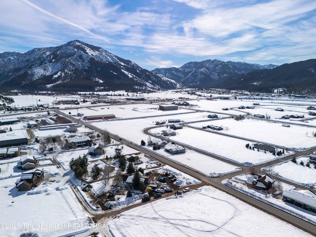 snowy aerial view featuring a mountain view
