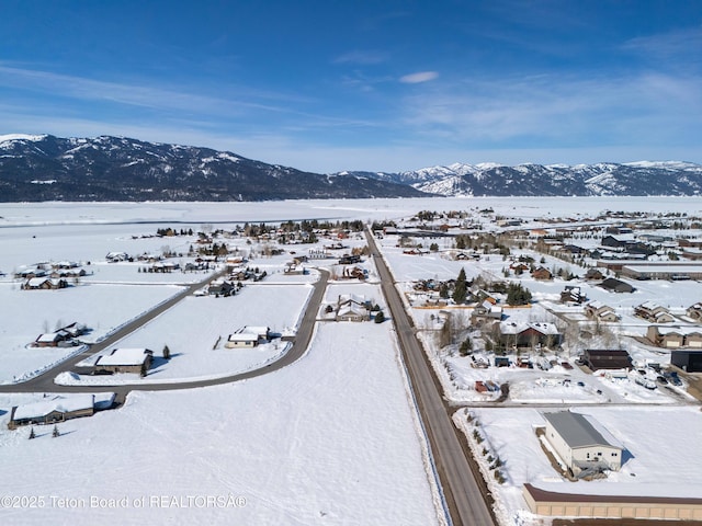 snowy aerial view featuring a mountain view