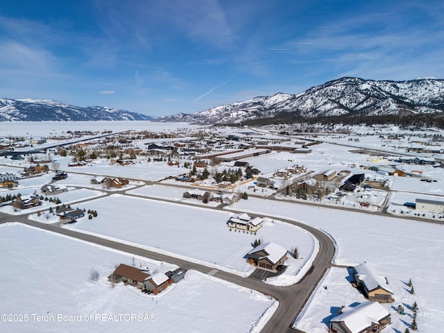 snowy aerial view featuring a mountain view