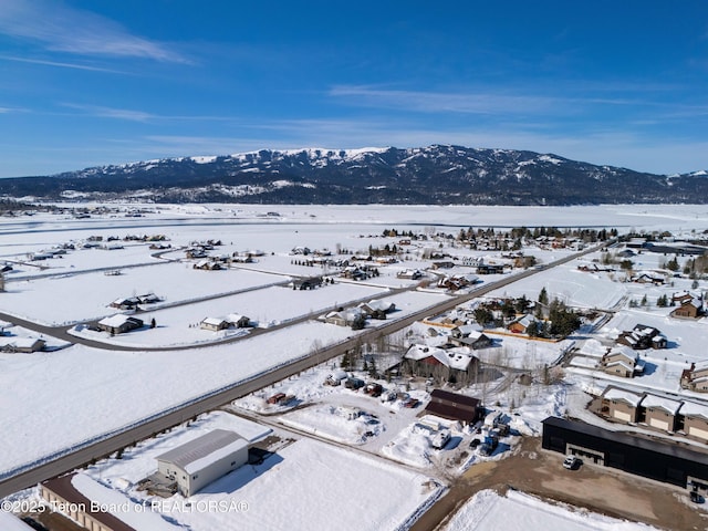snowy aerial view with a mountain view