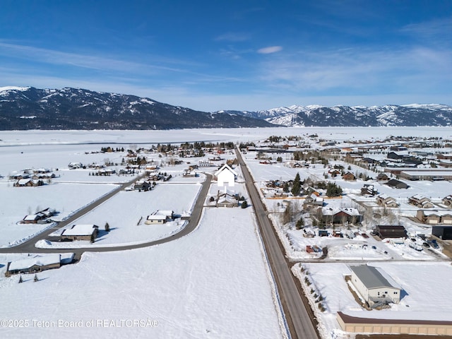 snowy aerial view with a mountain view
