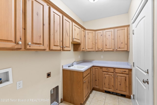 washroom with hookup for a washing machine, light tile patterned floors, hookup for an electric dryer, cabinet space, and a sink