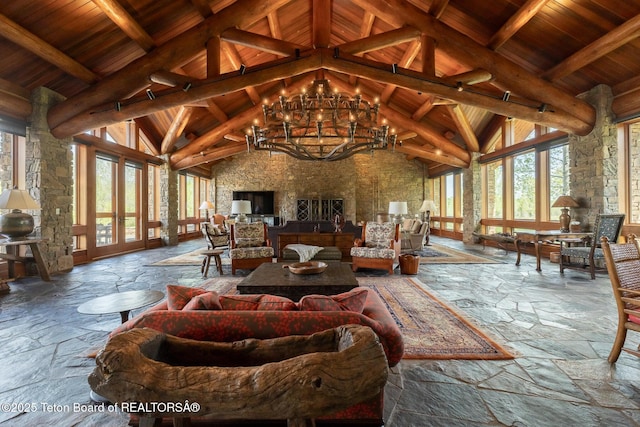 1525 S Thunder Rd, Wilson, WY 83014 - living room with wood ceiling with exposed beams, stone tile flooring, high vaulted ceiling, and a chandelier