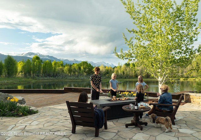 1525 S Thunder Rd, Wilson, WY 83014 - view of patio with an outdoor fire pit and a deck with water view