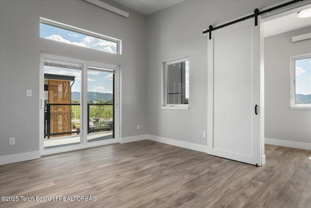 138 Larkspur Ave Unit 402, Victor, ID 83455 - unfurnished room featuring a barn door and light wood-type flooring