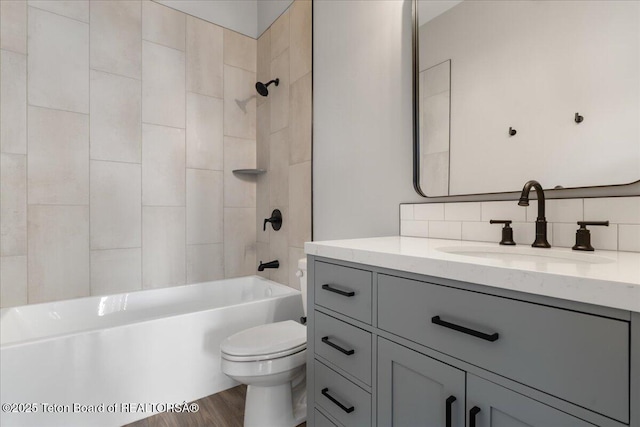 138 Larkspur Ave Unit 402, Victor, ID 83455 - full bathroom featuring vanity, backsplash, wood finished floors, and washtub / shower combination