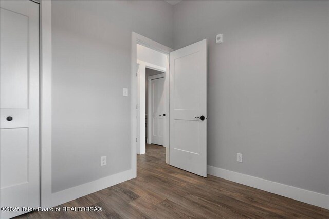 138 Larkspur Ave Unit 402, Victor, ID 83455 - unfurnished bedroom featuring baseboards and wood finished floors
