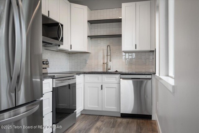 138 Larkspur Ave Unit 402, Victor, ID 83455 - kitchen with appliances with stainless steel finishes, open shelves, backsplash, and white cabinetry