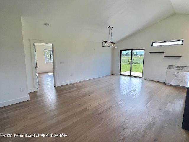 1714 River Meadows Dr, Victor, ID 83455 - unfurnished living room with lofted ceiling and light wood finished floors