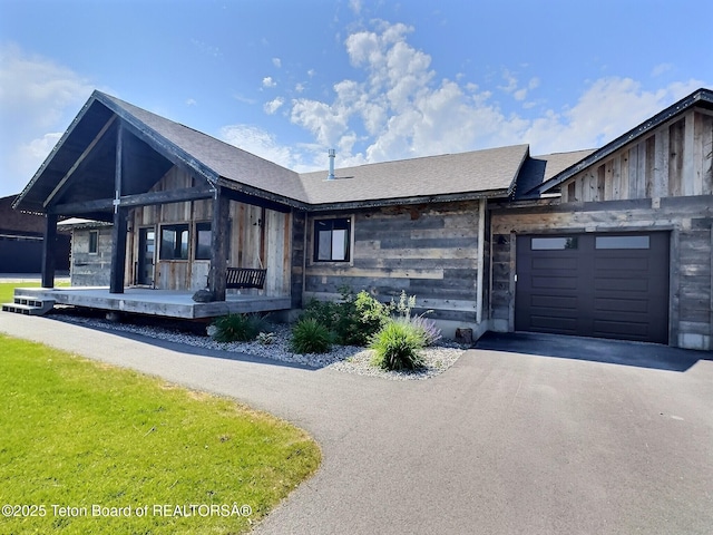 1714 River Meadows Dr, Victor, ID 83455 - view of front of property with covered porch, asphalt driveway, and a garage