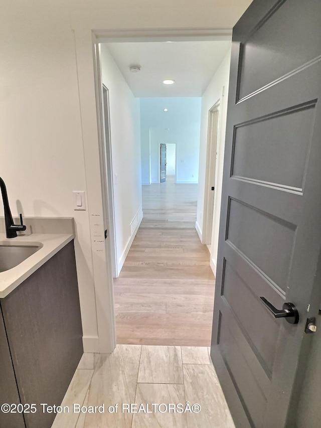 1714 River Meadows Dr, Victor, ID 83455 - hall featuring a sink and light wood-style flooring