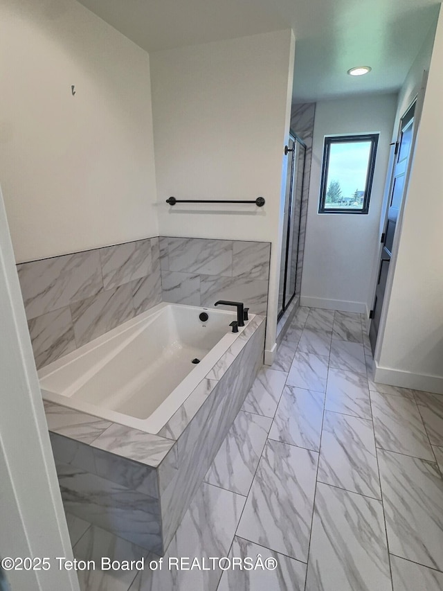 1714 River Meadows Dr, Victor, ID 83455 - full bath featuring a garden tub, a stall shower, and marble look tiles
