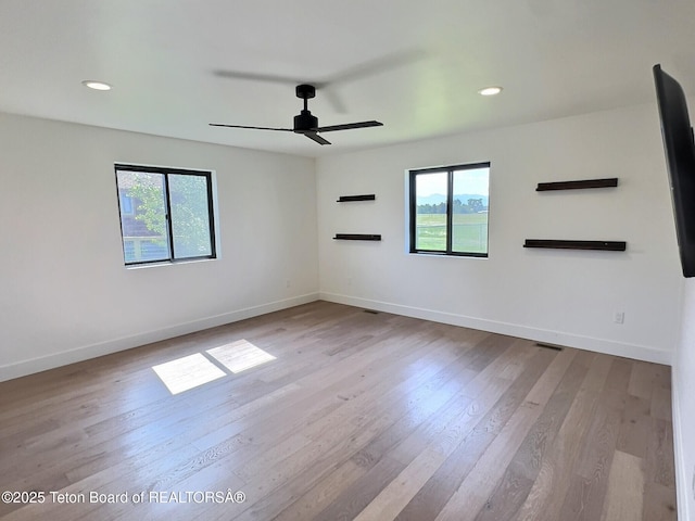 1714 River Meadows Dr, Victor, ID 83455 - spare room featuring healthy amount of natural light, ceiling fan, wood finished floors, and recessed lighting