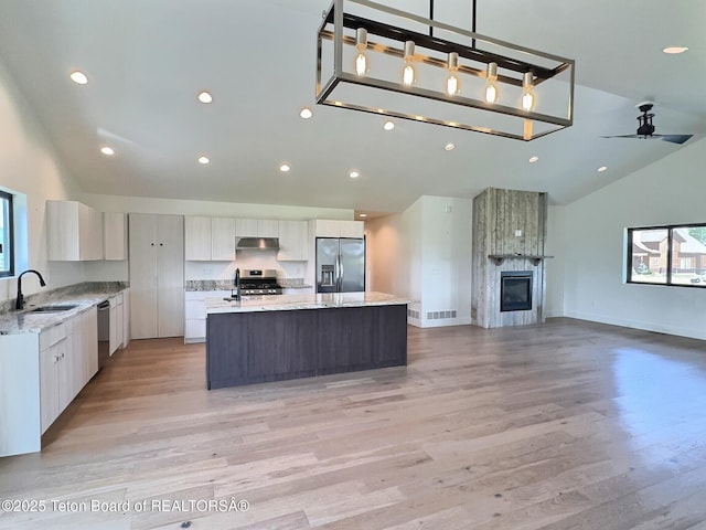 1714 River Meadows Dr, Victor, ID 83455 - kitchen featuring appliances with stainless steel finishes, open floor plan, a kitchen island with sink, light wood-type flooring, and recessed lighting