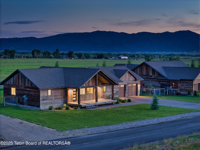 1714 River Meadows Dr, Victor, ID 83455 - view of front of property featuring a mountain view, driveway, a front yard, and an attached garage