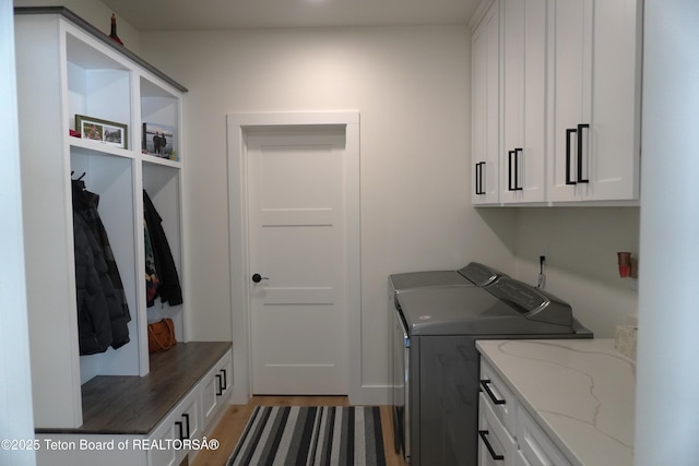 825 Mccoy Dr, Pinedale, WY 82941 - washroom featuring cabinet space, independent washer and dryer, and light wood-style floors