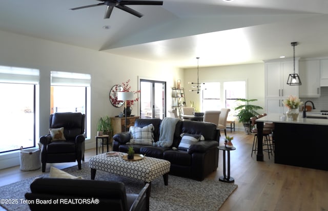 825 Mccoy Dr, Pinedale, WY 82941 - living area with lofted ceiling, ceiling fan, a healthy amount of sunlight, and light wood-style floors