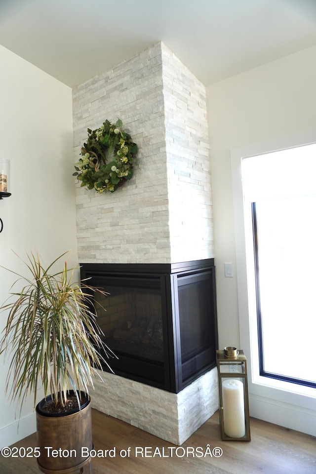 825 Mccoy Dr, Pinedale, WY 82941 - details featuring a stone fireplace and wood finished floors