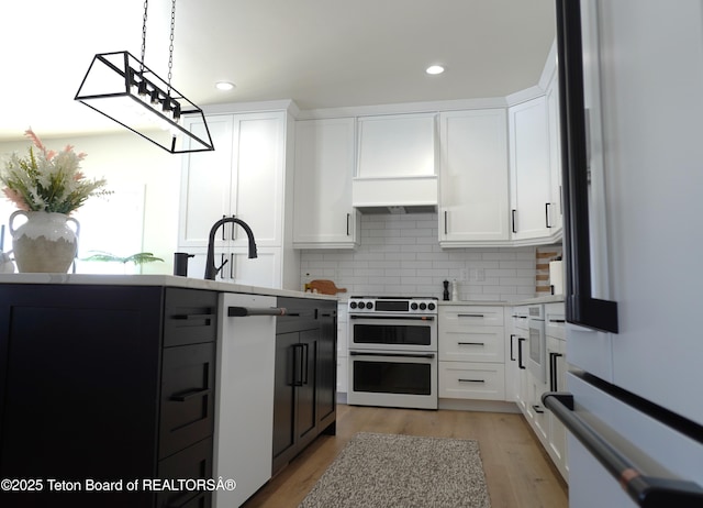 825 Mccoy Dr, Pinedale, WY 82941 - kitchen featuring decorative backsplash, light countertops, and double oven range