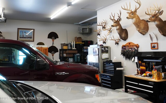 825 Mccoy Dr, Pinedale, WY 82941 - garage featuring a workshop area and a wall unit AC