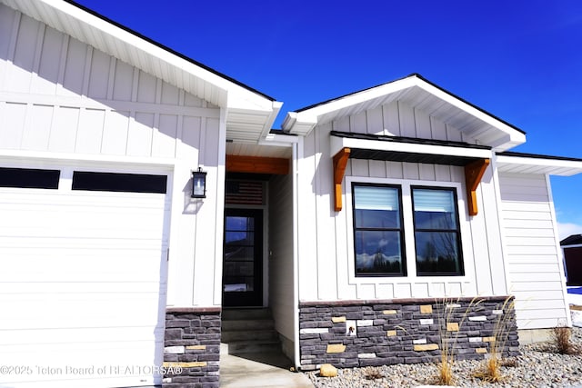 825 Mccoy Dr, Pinedale, WY 82941 - view of exterior entry with an attached garage and board and batten siding