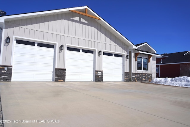 825 Mccoy Dr, Pinedale, WY 82941 - exterior space with stone siding, an attached garage, board and batten siding, and concrete driveway
